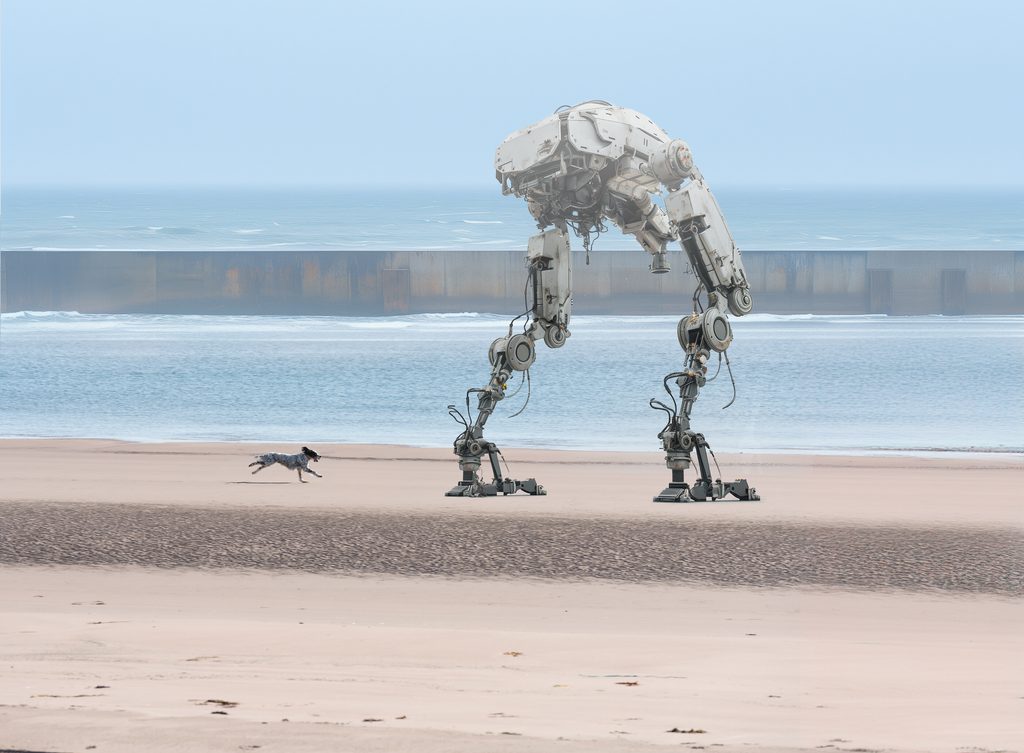 Giant mechanical robot walking along a misty beach with a dog running beside it, against the backdrop of a vast ocean and distant walls.